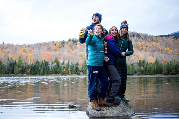 Student+stand+near+a+lake+in+the+mountains